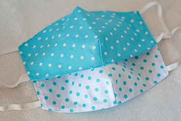 Selective focus on handmade fabric cotton reversible face masks Top view. Protection against saliva, cough, dust, pollution, virus, bacteria, COVID-19.