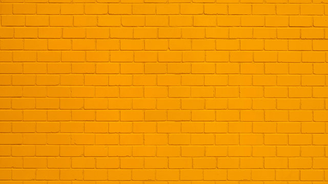 Texture of a orange painted brick wall as a background or wallpaper