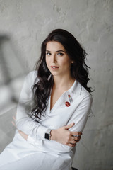 Fashion luxury lady in shirt. Photography of a Attractive girl. Beauty woman in white shirt posing in grey studio. Trendy portrait of seductive sexy girl model in underwear.