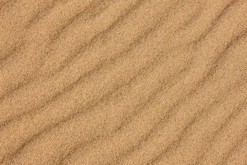 Fototapeta na wymiar The rippled beach sand, partially frozen, runs diagonally on the beach at Harrington Beach State Park, Belgium, Wisconsin in late November
