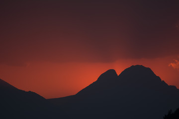 A sunset with the silhouette of the Pedraforca, a famous mountain in Catalonia.
