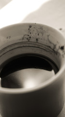 Black and white artistic black coffee cup close up