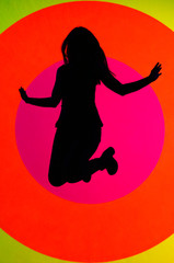 Young, attractive fit woman, jumping up, showing her positive attitude and joy. oval and colorful texture in background 