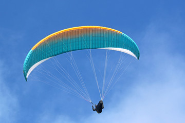 Paraglider flying wing in a blue sky	