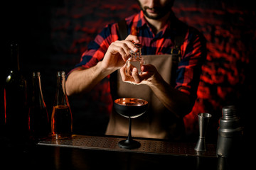 man at bar holds in his hand large piece of ice.