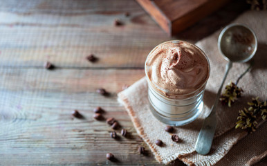 Iced frothy drink Dalgona Coffee, trend korean drink latte espresso with coffee. Gray concrete background.
