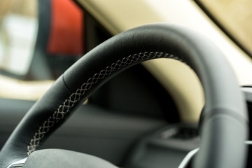 Close-up steering wheel of a car. leather steering wheel. Technology concept.Selective focus