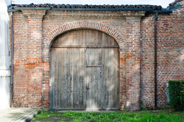 Plakat ancient wooden door with brick masonry