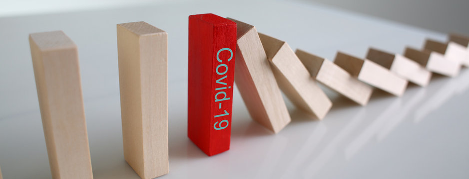 Red Wooden Block With Covid19 Sign Close-up Background. Coronavirus Covid 19 Stop Concept.