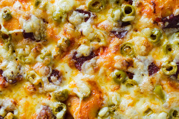 Pizza texture. Freshly baked appetizing pizza. Food background.