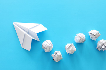 education or innovation concept. paper origami plane over blue background