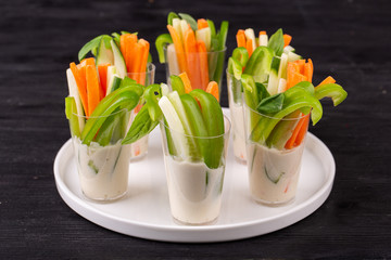 Sweet Bulgarian pepper, fresh cucumbers and carrots with cream sauce