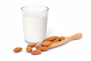 Glass of Almond milk and almond nuts in wooden scoop isolated on white background. Healthy drinks, natural protein concept.