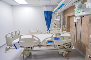 Empty adjustable patient's bed in hospital room for medical treatment and rehabilitation