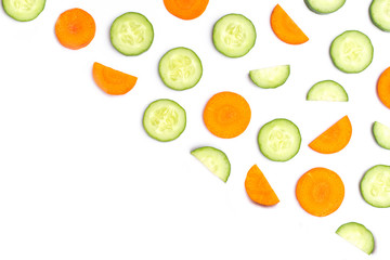 Cucumber and carrot slices isolated on white background. Beauty and spa products concept. Top view. Flat lay.