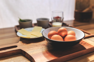 Eggs, cheese, olives, spinach, greens, tomatoes, a glass of milk.