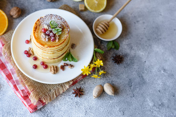 Delicious fresh beautiful pancakes with citrus honey and jam