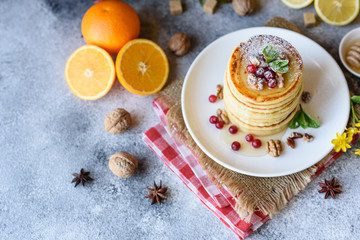 Delicious fresh beautiful pancakes with citrus honey and jam