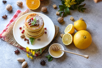 Delicious fresh beautiful pancakes with citrus honey and jam