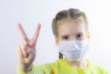 Glad and happy beautiful joy,child in the medical helthcare guarding or protecting mask and in yellow t-shirt on the white background for easy extraction