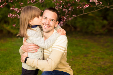 Close up portrait pretty daughter embracing Caucasian father. Family enjoy spend time together.