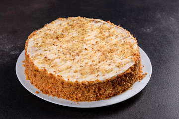 Fresh delicious carrot cake with cream on a dark background