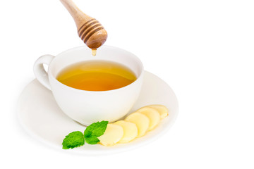 Closeup hot ginger tea in ceramic cup and honey with fresh organic ginger slice isolated on white background . Healthy drinks and  food booster immune system concept.