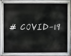 # COVID-19 written text on black chalkboard with white frame.