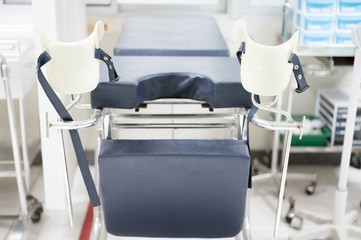 Empty gynecological chair in the clinic.Gynecological bed on the obstetrics and gynecology department in the hospital.Medical equipment concept.