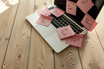 Image of laptop full of sticky notes reminders on screen. Work overload concept image. Coworking or working at home concept image.
