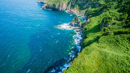 Fototapeta premium Aerial view of green coast line