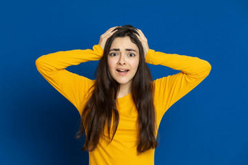 Brunette young girl wearing yellow jersey