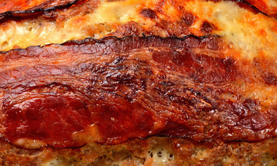 Tasty baked pork meatloaf in pan. Macro photography.