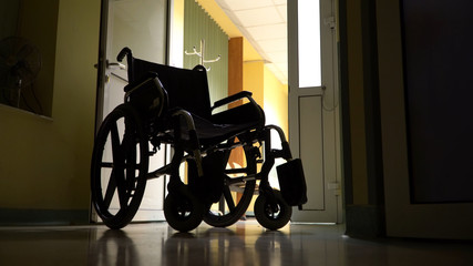 Empty wheelchair parked in hospital hallway
