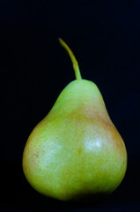 ripe tasty pear on a dark background