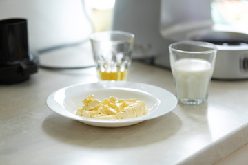 Ingredients for making sweet cream. Butter melts in a plate