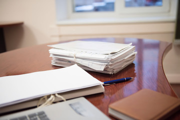 Pile of unfinished documents on office desk, Stack of business paper. A file folders  with documents and important documents. 