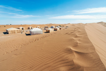 Very nice camp with a few tents surrounded by sand dunes of Sahara desert, Morocco