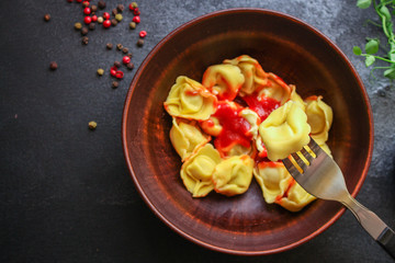 tortellini, pasta with filling (ravioli or dumplings)
second course
Menu concept. food background. top view copy space for text