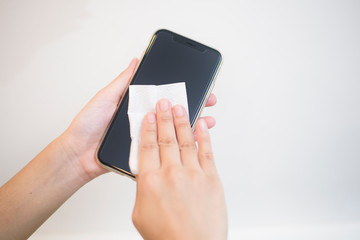 woman is cleaning cell phone