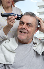 Woman cutting a man's hair at home