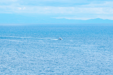 The little touristic ferry is sailing in open waters in Amalfi gulf