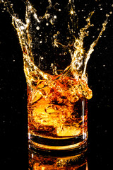 splash glass of whiskey ices