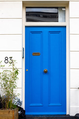 Blue house door with the number 83