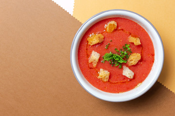 Homemade tomato soup with bread, mint and olive oil