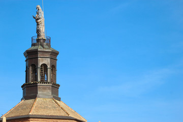 Fototapeta na wymiar Statue on the top of Guadix cathedral bell tower, Spain