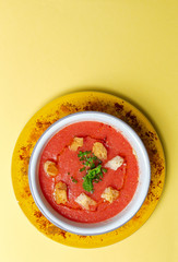 Homemade tomato soup with bread, mint and olive oil