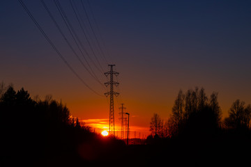 Fototapeta premium High voltage towers aganist the beautiful sunset
