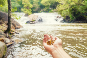 young woman relaxing in waterfall