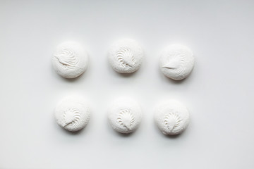 White sweet dessert zephyr marshmallows on white background. Confectionery. Even, organized, simple.